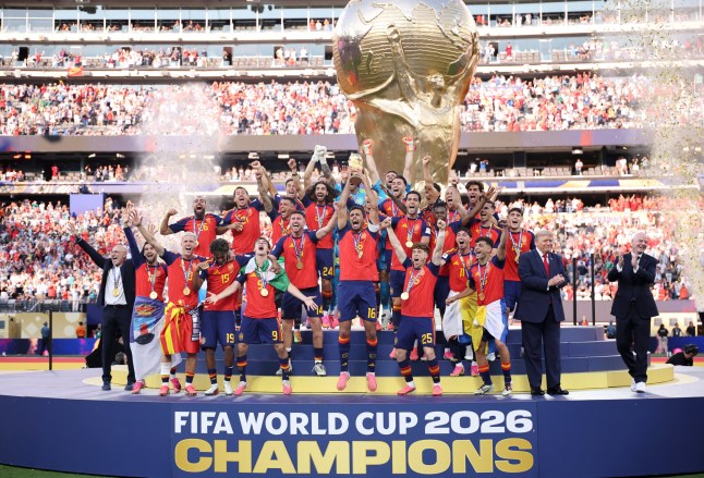 EAST RUTHERFORD, NEW JERSEY - JULY 19: Rodri #16 of Spain lifts the FIFA World Cup Winner???s Trophy alongside U.S. President Donald Trump and FIFA President Gianni Infantino after the team???s victory following during the FIFA World Cup 2026 Final match between Spain and Argentina at New York New Jersey Stadium on July 19, 2026 in East Rutherford, New Jersey. (Photo by Hector Vivas - FIFA/FIFA via Getty Images)