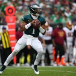 Jalen Hurts throws 3 TD passes and Eagles stuff Commanders’ late 2-point try for 24-22 win